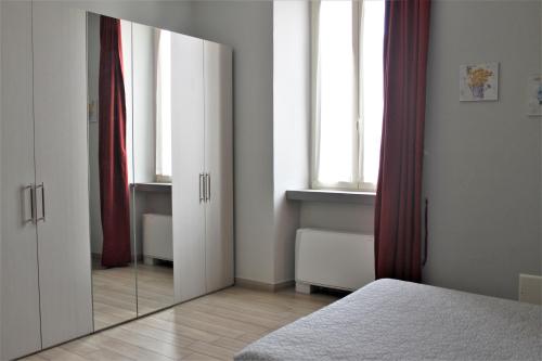 a bedroom with a large mirror in front of a bed at La Viscontina in Somma Lombardo