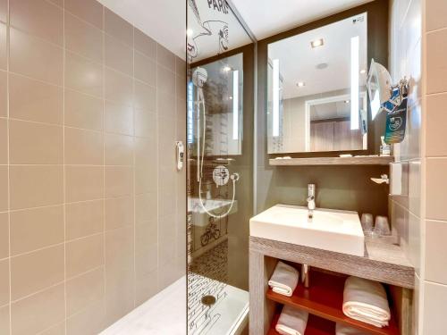 a bathroom with a sink and a shower at Mercure Paris Gare Montparnasse in Paris