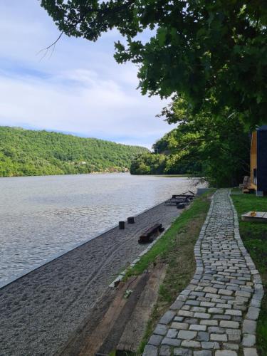 a stone path next to a body of water at Cabana Bahna in Iloviţa