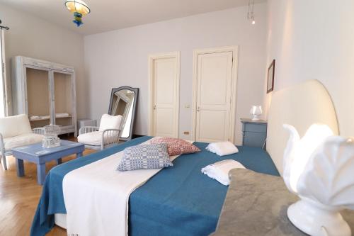 a bedroom with a large bed with a blue blanket at Relais Delle Rose in Lecce