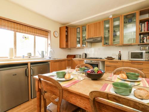 a kitchen with a wooden table with bowls of fruit on it at Bedford Terrace in Bridport