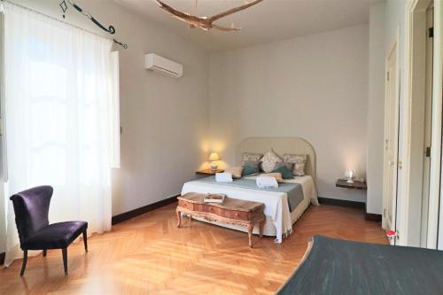 a bedroom with a bed and a table and a chair at Relais Delle Rose in Lecce