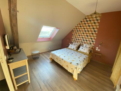 a bedroom with a large bed and a window at Chambres d hôtes de la Mauguinière in Neuillé-le-Lierre