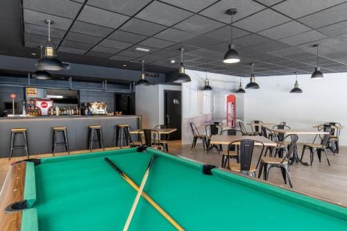 a pool table in a restaurant with tables and chairs at Aparthotel BCL Levante Lux in Benidorm