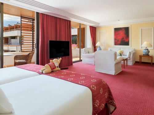 a hotel room with a large bed and a large window at Hotel Botanico y Oriental Spa Garden in Puerto de la Cruz