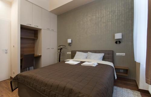 a bedroom with a large bed with two towels on it at NN Apartman Budapest in Budapest