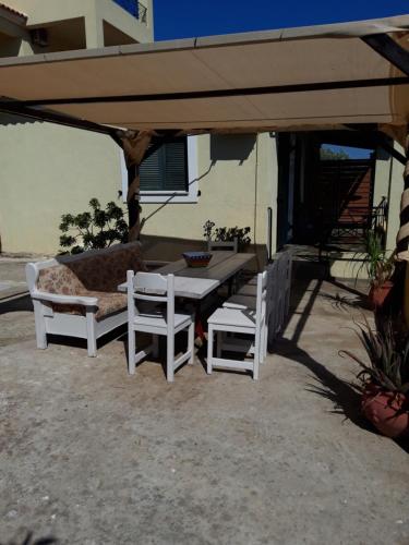 a table and two chairs under an umbrella at Elaia country living in Galatas