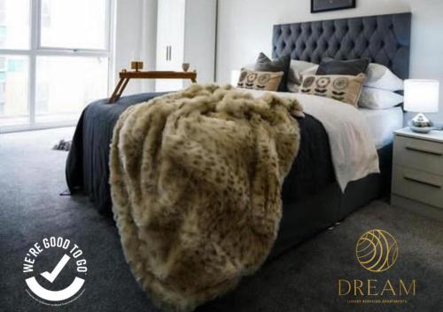 a bed that has a blanket on it at Dream Luxury Serviced Apartments Manchester in Manchester