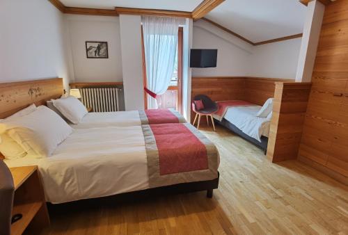 Postel nebo postele na pokoji v ubytování Hotel Croux