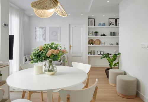 a white dining room with a white table and chairs at Moneo by FeelFree Rentals in San Sebastián
