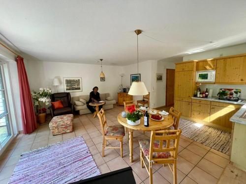 a living room with a table and a kitchen at Haus Wieck auf dem Darß in Wieck