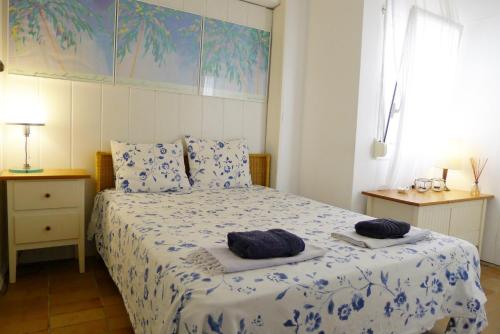 a bedroom with a bed with two towels on it at Fragata Beach Seaview in Sitges