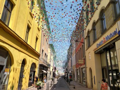 a bunch of umbrellas hanging over a city street at Number15 Guesthouse Carcassonne in Carcassonne