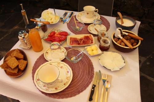 a table topped with plates of food on a table at Casa Rural Chao de Castro in Ríodeporcos