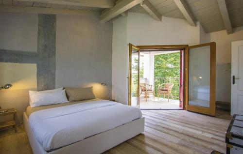 a bedroom with a bed and a sliding glass door at Capriva Del Friuli - CASA RONCUS in Capriva del Friuli