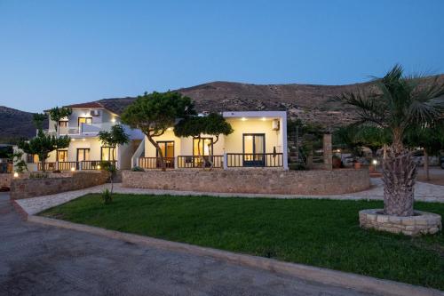 a house with a palm tree in a yard at Adam in Falasarna