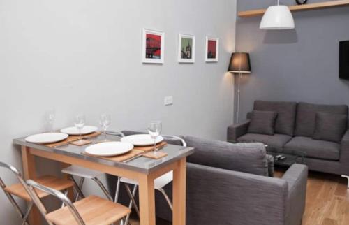 a living room with a table and a couch at Royal Mile Apartment in Edinburgh