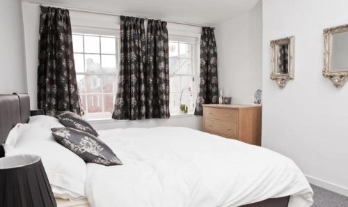 a bedroom with a white bed and a window at Royal Mile Apartment in Edinburgh