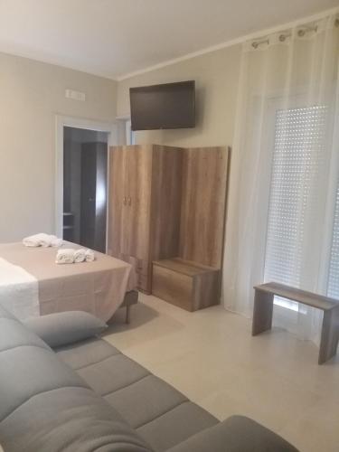 a bedroom with a bed and a tv on the wall at B&B La Dolce Vita in Campomarino