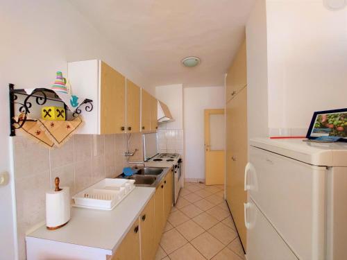 una pequeña cocina con fregadero y lavavajillas en Apartman Ninsky en Primošten