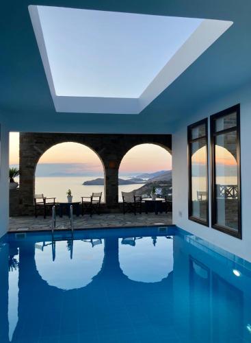 a house with a swimming pool with a view at SYROU LOTOS Studios & Apartments in Kinion
