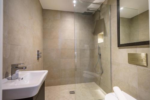 a bathroom with a shower and a sink and a shower at City Pad @ Ryedale House in York