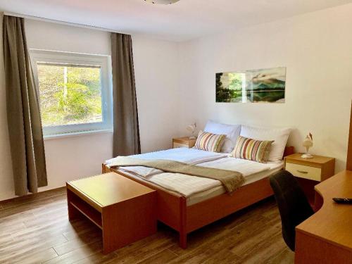 a small bedroom with a bed and a window at Zelena Oaza in Zgornja Kungota