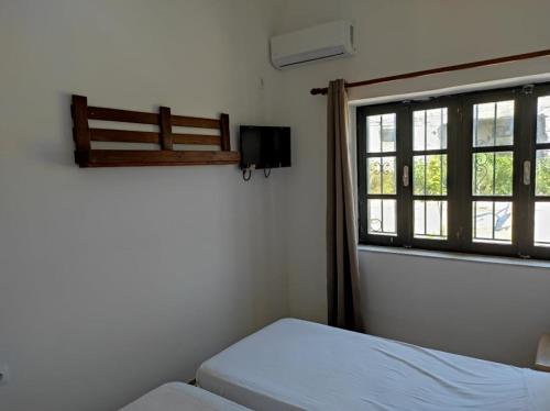 a bedroom with a bed and a window at San Marco Guesthouse in Kattavía