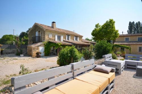 a house with a bench in front of it at chambres d hotes Le Mas Julien piscine chauffée adult only in Orange