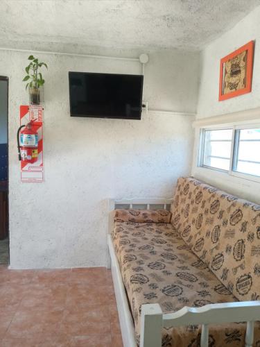 a living room with a couch and a flat screen tv at Casa de Alquiler 1 in Tanti
