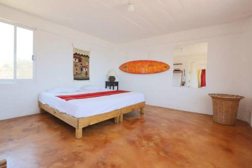 a bedroom with a large bed and a large window at Casa Macondo in Puerto Ángel