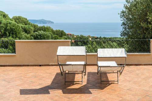 two chairs sitting next to each other on a patio at Ibisco in Pisciotta