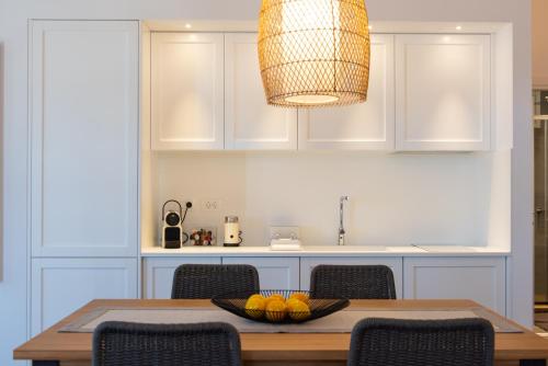 a kitchen with a table with a bowl of fruit on it at NIREAS STONEHOUSE IN APOLLONIA SIFNOS in Sifnos