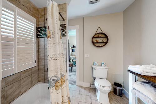 a bathroom with a toilet and a shower at Malibu Beach House in Dauphin Island