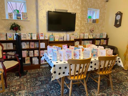 a table with books on it in a room at The Homestar in Skegness