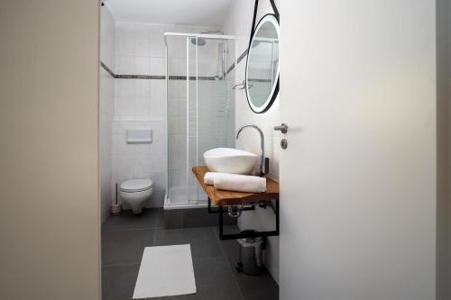 a bathroom with a sink and a shower at Apartments Domic in Banjole