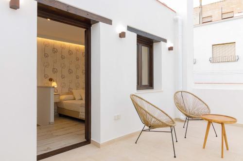 a living room with two chairs and a table at Hostal Peñiscola in Peñíscola