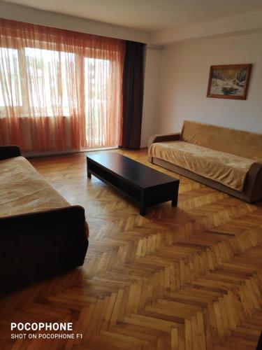 a living room with a couch and a coffee table at Iris&carina in Eforie Sud