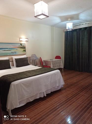 Katil atau katil-katil dalam bilik di Pousada Presidente Hotel