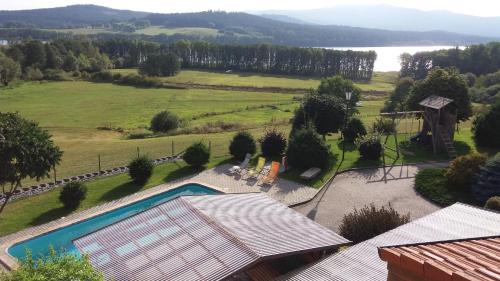 an aerial view of a house with a swimming pool at Apartmány U Srdce Vltavy in Horní Planá