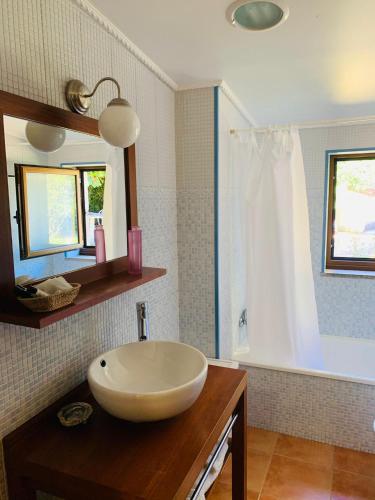 a bathroom with a white sink and a mirror at Pedreiras Cottage Rias Baixas in Pontevedra