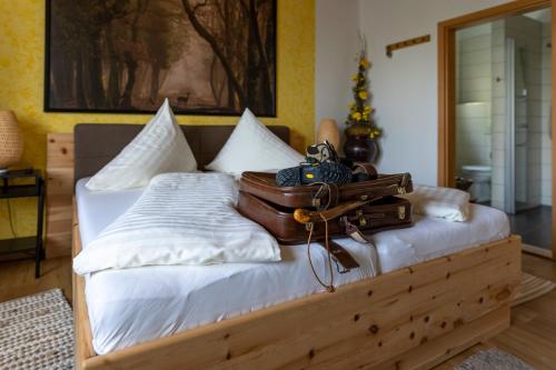 a pile of luggage sitting on top of a bed at Privatzimmer Haring in Kitzeck im Sausal