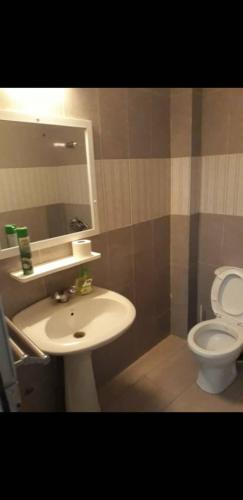 a bathroom with a sink and a toilet at Appartement Beau Séjour in Dakar