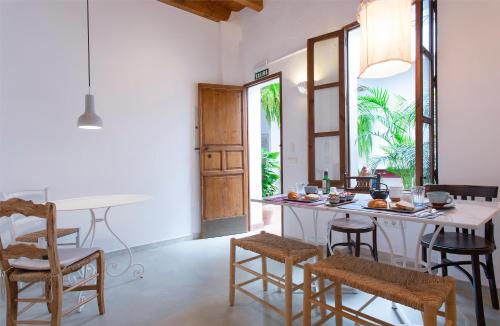 a kitchen with a counter and chairs and a table at La Morada Mas Hermosa in Marbella