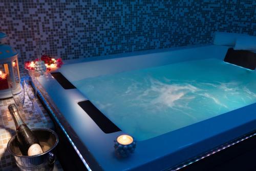 a blue bath tub with a candle and lights in it at Casa Blandano B&B in Castelmola