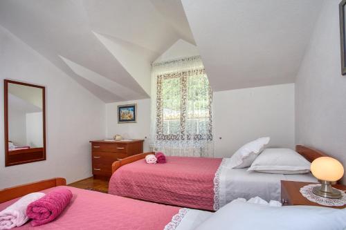 a bedroom with two beds and a window at Apartment Birdie with private pool and mini golf in Gata