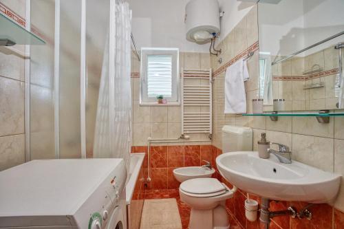 a bathroom with a white sink and a toilet at Apartment Birdie with private pool and mini golf in Gata
