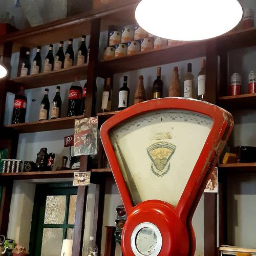 a red item in a room with bottles on shelves at Hospedaje Leñas del Tolosa in Las Cuevas