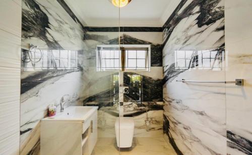 a bathroom with a sink and a glass shower at 44 La Pirogue in Ballito