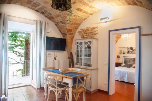 a dining room with a table and a bedroom at loft sul mare Sirolo in Sirolo